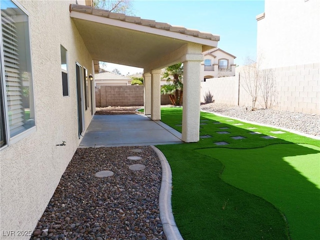 view of yard with a fenced backyard and a patio