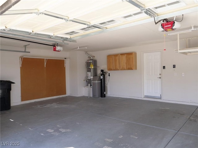 garage featuring a garage door opener and secured water heater