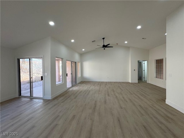 spare room featuring ceiling fan, recessed lighting, baseboards, vaulted ceiling, and light wood-type flooring