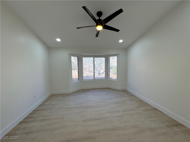 empty room with light wood-type flooring, baseboards, a ceiling fan, and recessed lighting