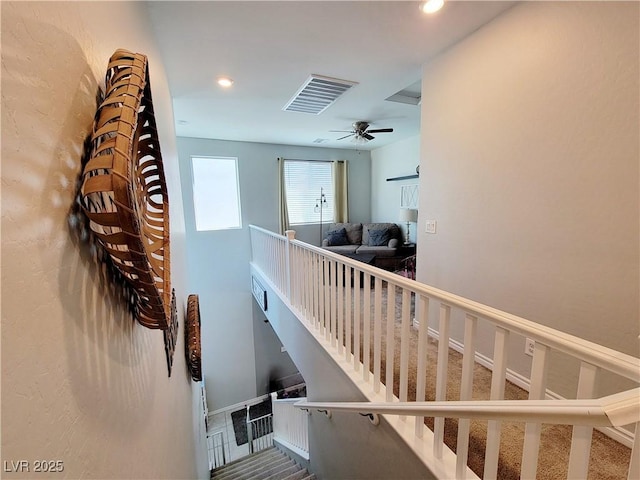 staircase featuring carpet flooring, visible vents, and recessed lighting