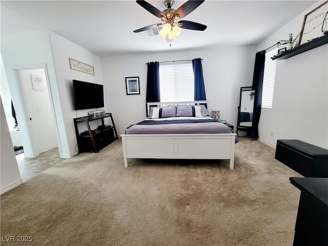 bedroom featuring light carpet, ceiling fan, and baseboards