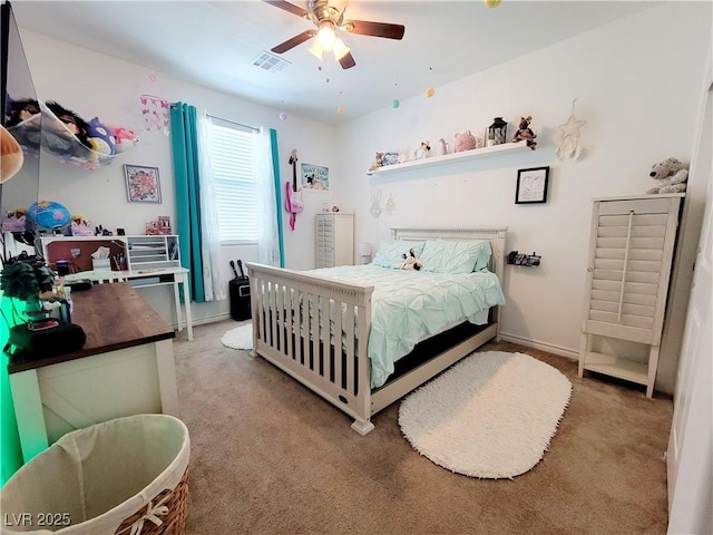 carpeted bedroom featuring baseboards, visible vents, and a ceiling fan