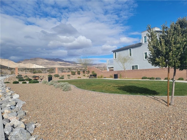 view of yard with fence and a mountain view