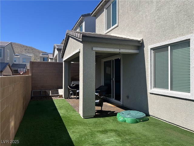 view of yard featuring fence and a patio