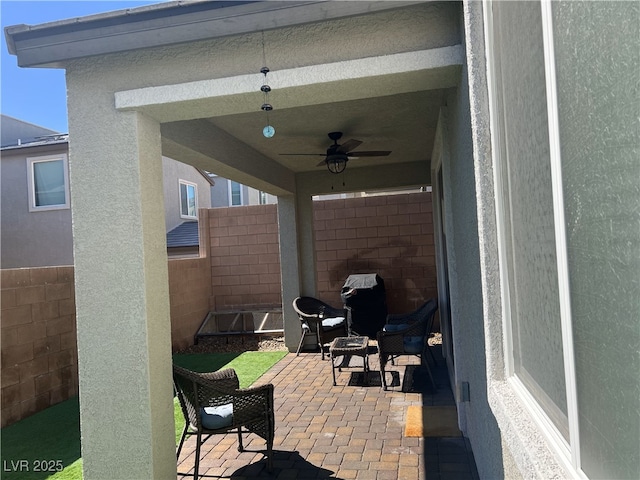 view of patio / terrace featuring fence and a ceiling fan