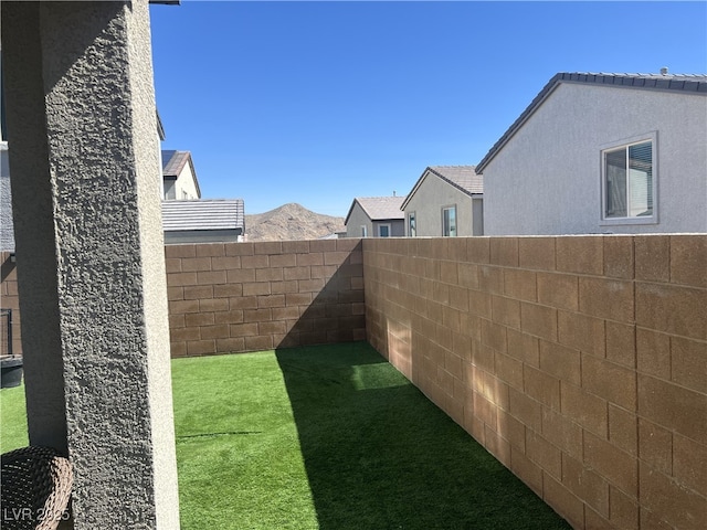 view of yard featuring a fenced backyard and a mountain view