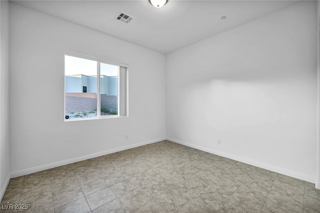 empty room featuring visible vents and baseboards