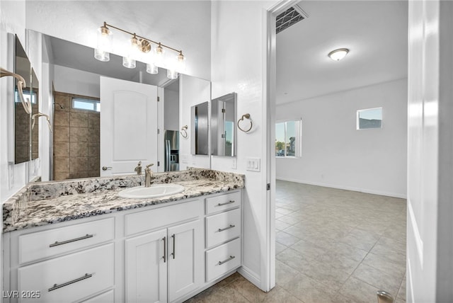 full bath featuring baseboards, visible vents, and vanity