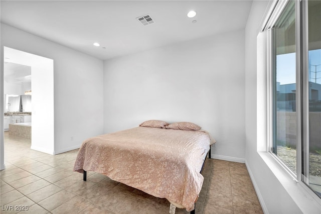 bedroom with baseboards, visible vents, ensuite bath, tile patterned flooring, and recessed lighting