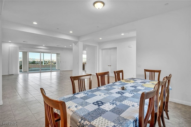 dining space with baseboards, light tile patterned flooring, and recessed lighting