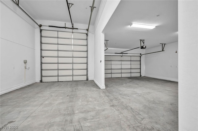 garage with baseboards and a garage door opener