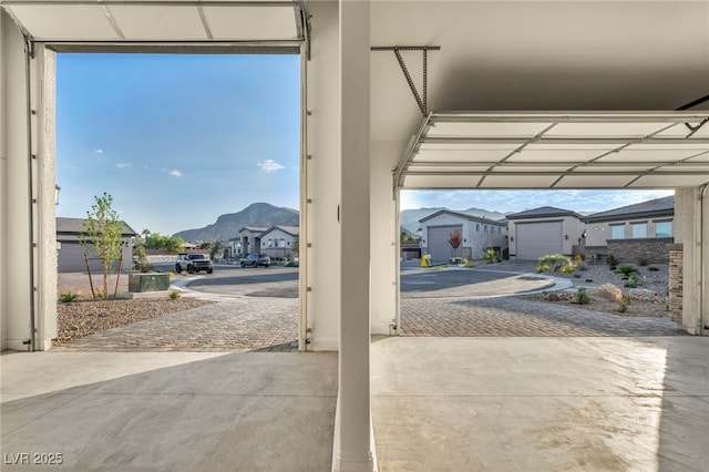 garage featuring decorative driveway and a mountain view