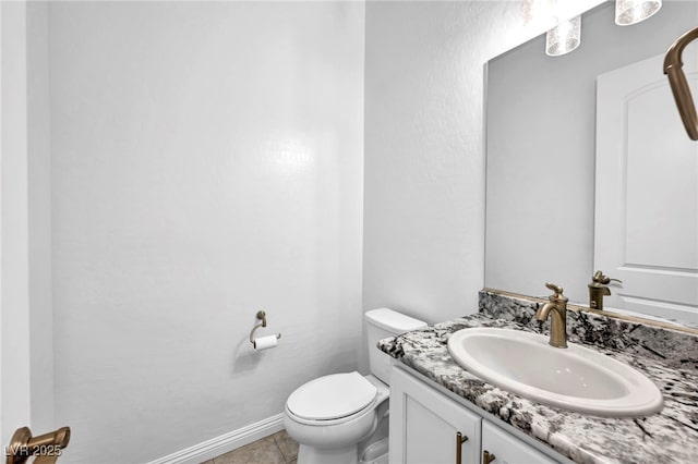 half bath with baseboards, vanity, toilet, and tile patterned floors