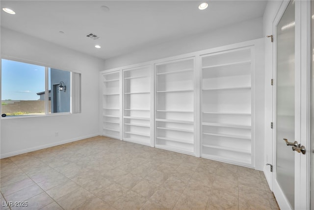 spare room with baseboards, visible vents, and recessed lighting