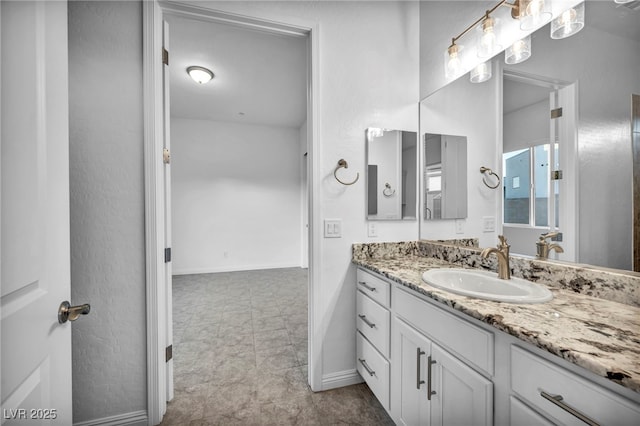 bathroom with vanity and baseboards