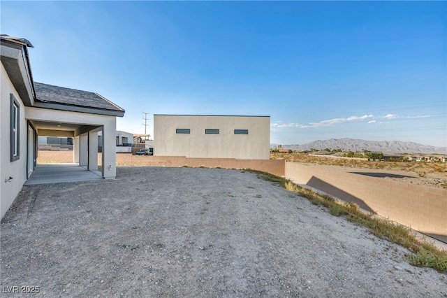 view of property exterior featuring a mountain view and stucco siding