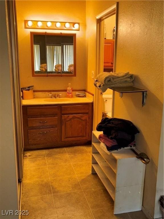 bathroom featuring tile patterned flooring and vanity