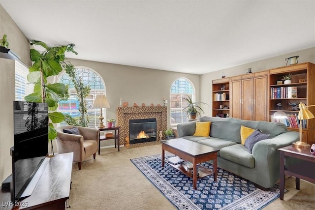 living room with light carpet and a glass covered fireplace