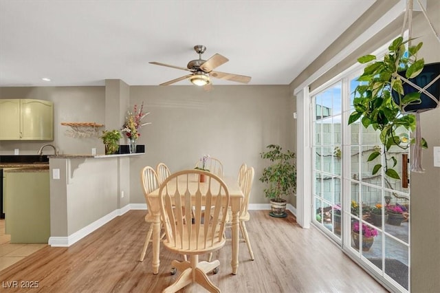 dining room with light wood finished floors, recessed lighting, a ceiling fan, and baseboards