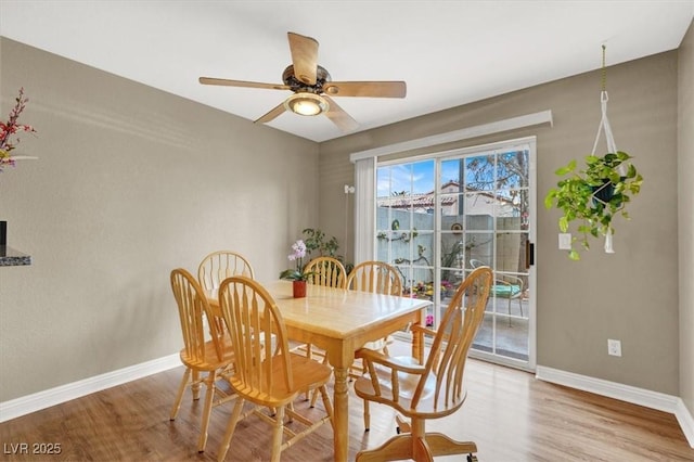 dining room with light wood-type flooring, ceiling fan, and baseboards