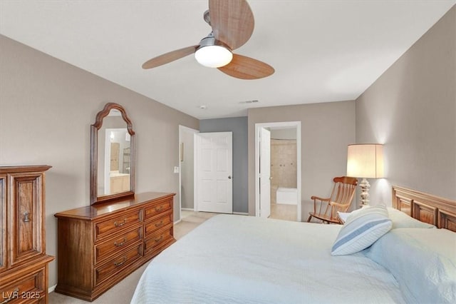 bedroom with a ceiling fan, visible vents, connected bathroom, and light colored carpet