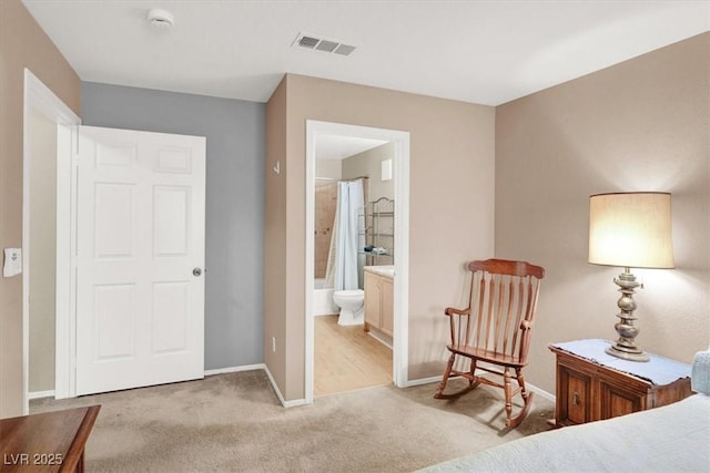 bedroom with light carpet, ensuite bath, visible vents, and baseboards