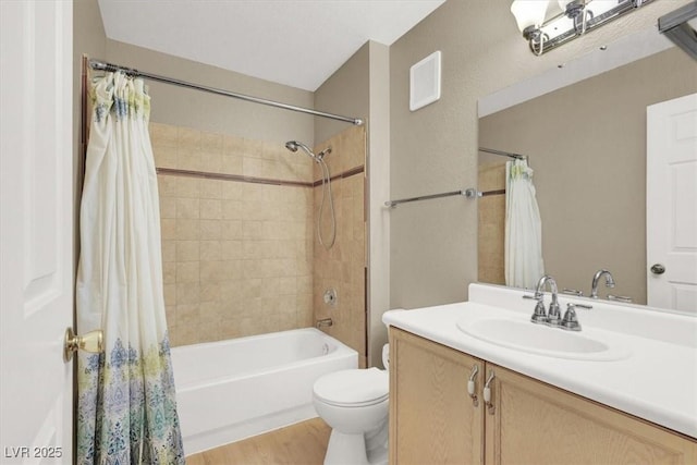 full bathroom with visible vents, toilet, shower / bath combo, vanity, and wood finished floors