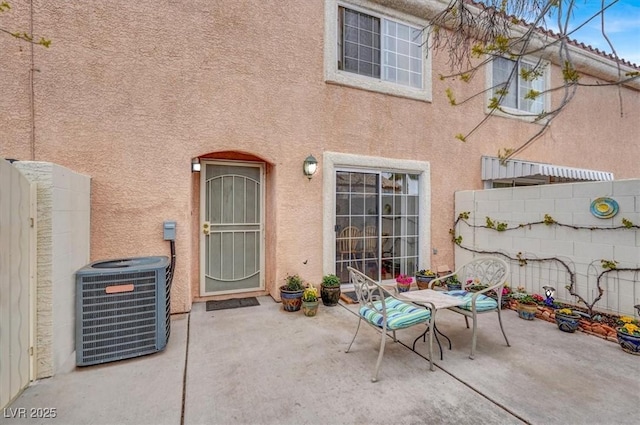 view of patio / terrace featuring cooling unit and a fenced backyard