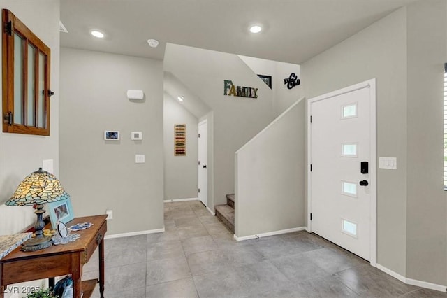 foyer entrance featuring recessed lighting, baseboards, and stairs