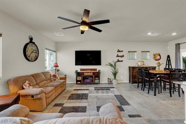 living area featuring recessed lighting, visible vents, ceiling fan, and baseboards