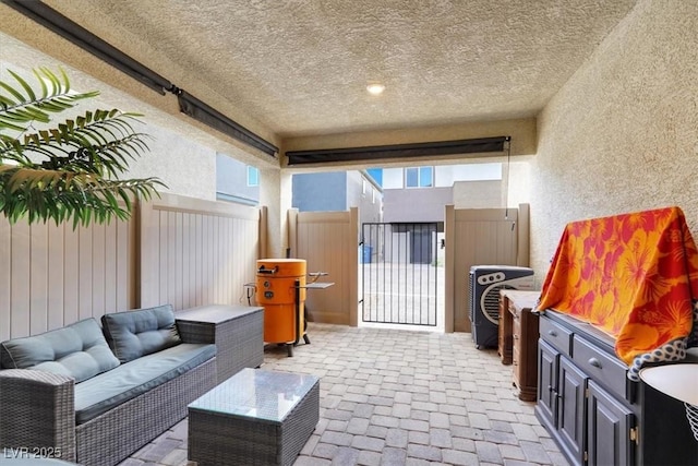 view of patio / terrace with a gate, fence, and an outdoor hangout area