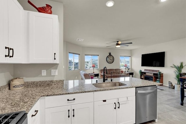 kitchen with a sink, open floor plan, range, light stone countertops, and dishwasher