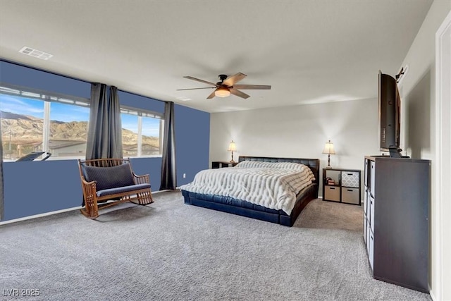 carpeted bedroom featuring ceiling fan and visible vents