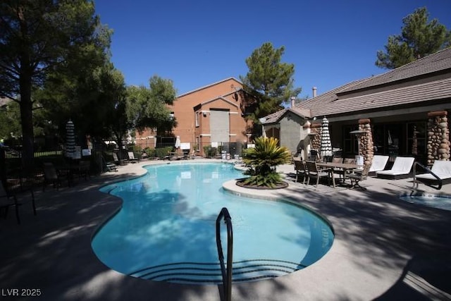 pool featuring a patio and fence