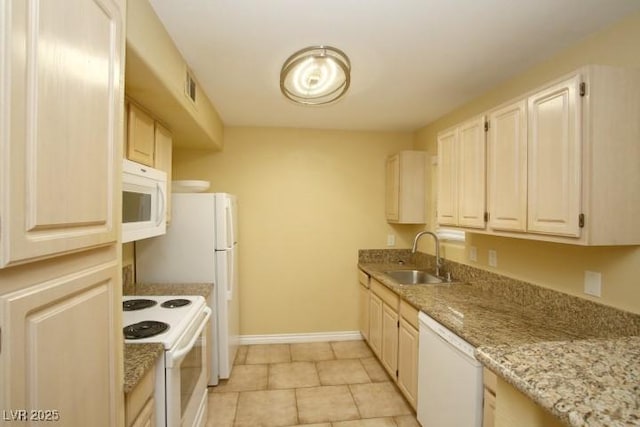 kitchen featuring light tile patterned floors, white appliances, a sink, visible vents, and baseboards