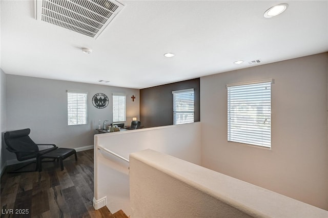 hall featuring visible vents, dark wood-style floors, an upstairs landing, and recessed lighting