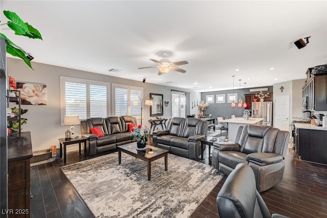 living area with dark wood-type flooring, recessed lighting, visible vents, and a ceiling fan