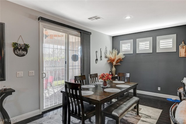 dining room with a wealth of natural light, visible vents, and baseboards