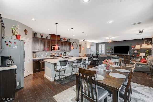 dining room featuring dark wood-style floors, recessed lighting, visible vents, and a ceiling fan