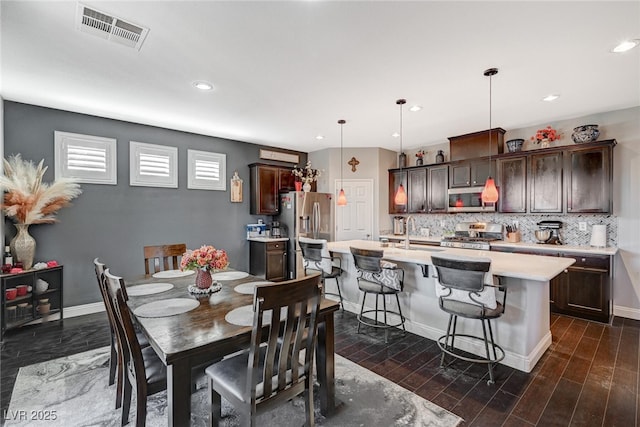 dining room featuring recessed lighting, dark wood-style flooring, visible vents, and baseboards