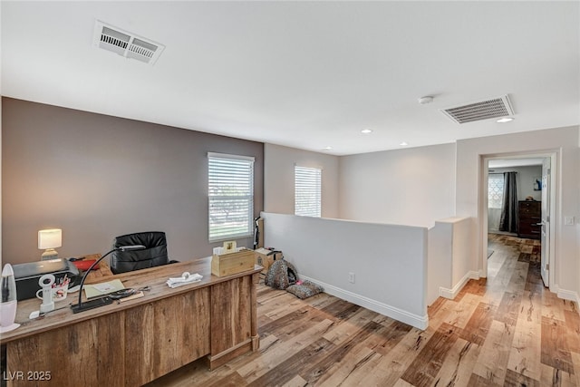 office space with light wood-style flooring, recessed lighting, visible vents, and baseboards