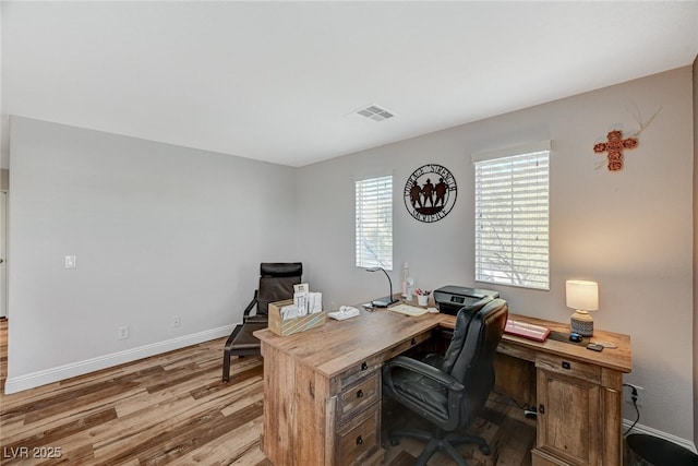 office featuring visible vents, baseboards, and wood finished floors