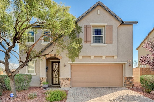 view of front of house featuring stone siding, a tiled roof, and stucco siding