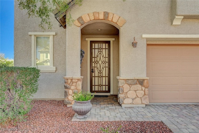 entrance to property with stone siding and stucco siding