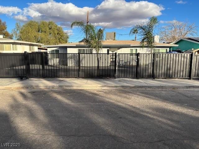 view of gate with a fenced front yard