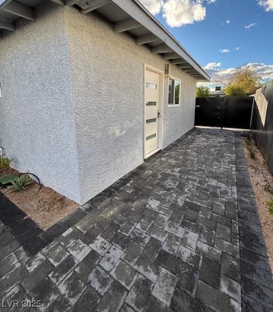 view of property exterior with a patio area, a fenced backyard, and stucco siding