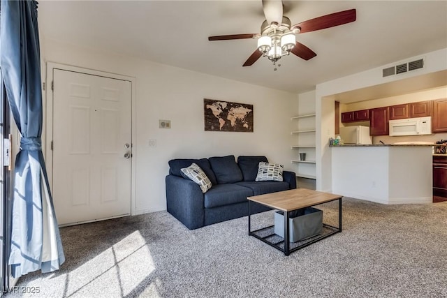 living room featuring a ceiling fan, baseboards, visible vents, and carpet flooring