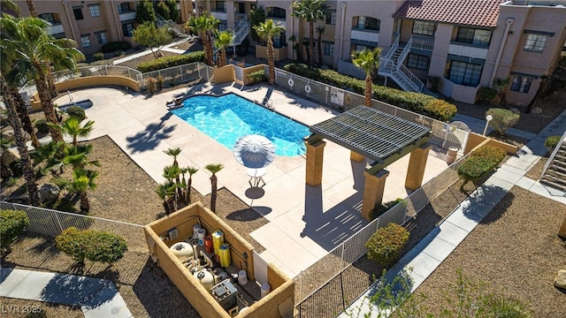 pool featuring a patio and fence