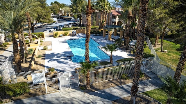 community pool with a fenced front yard and a gate